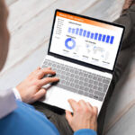 Man viewing website traffic analytics data on laptop computer